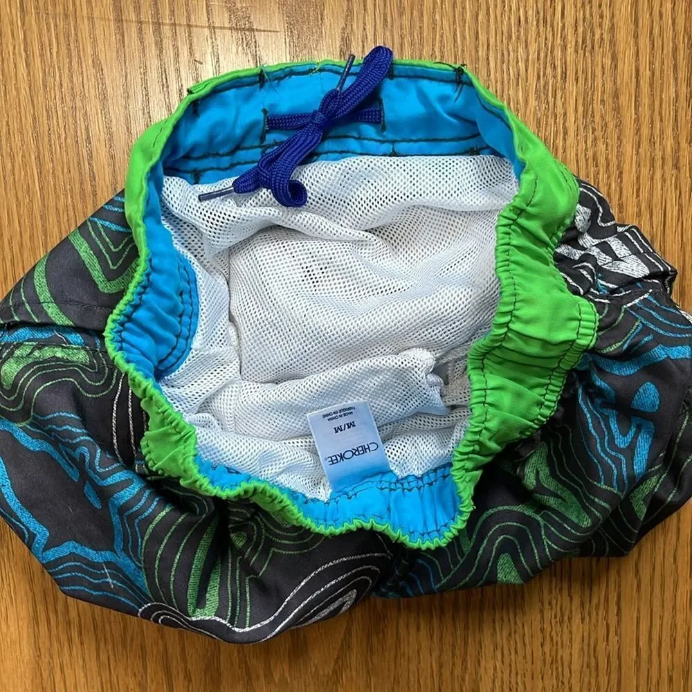 Cherokee swimming shorts. Drawstring waist. Size medium (10/12). Pockets.